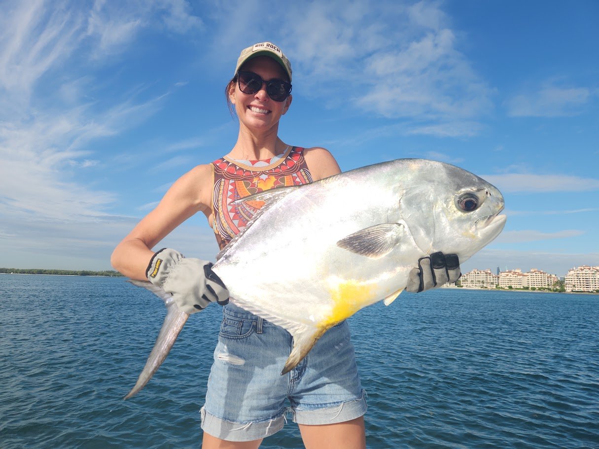 Nicky holding a large Miami permit caught while fishing in Biscayne Bay with Captain Tom Weber