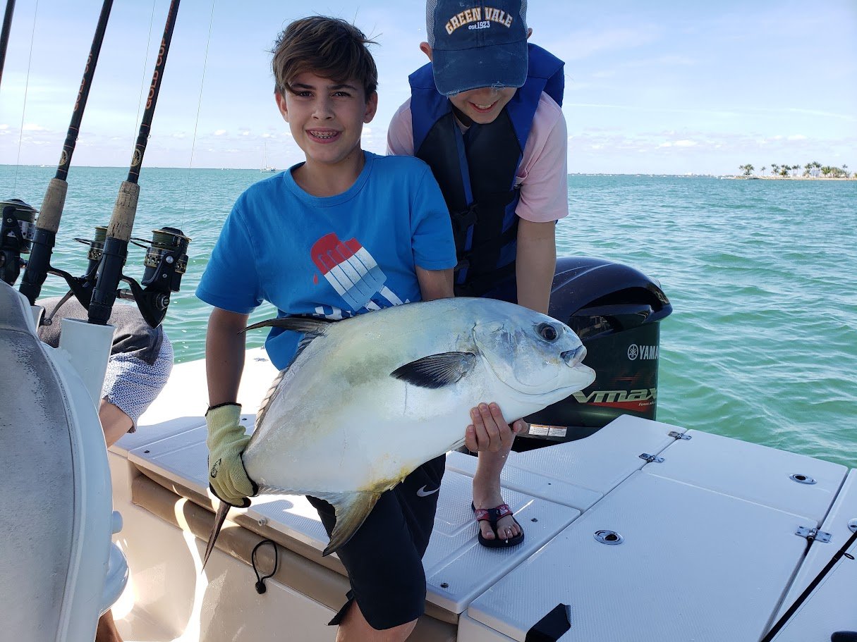 Kids catching permit on a Miami fishing charter