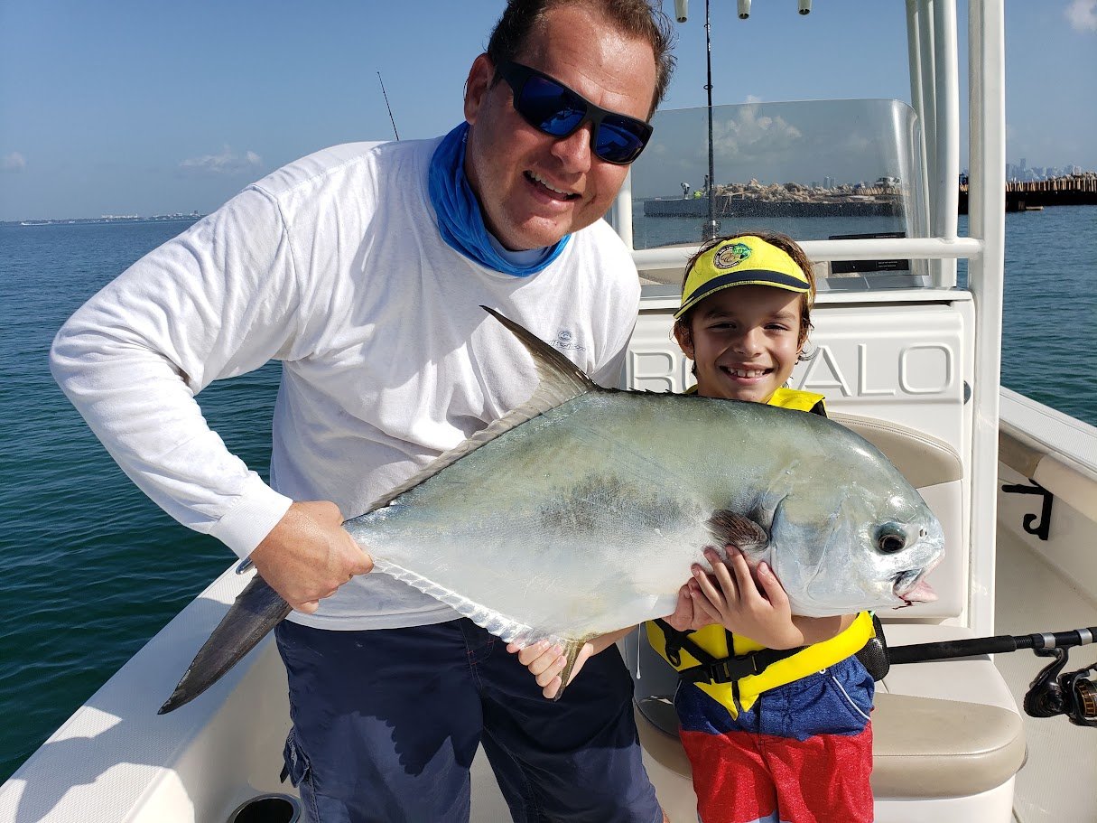 Kid holding a permit caught in Key Biscayne